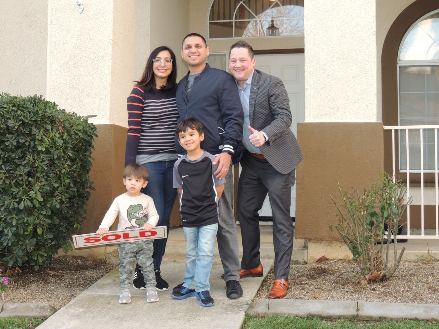 First time buyer family with a SOLD sign in Galt